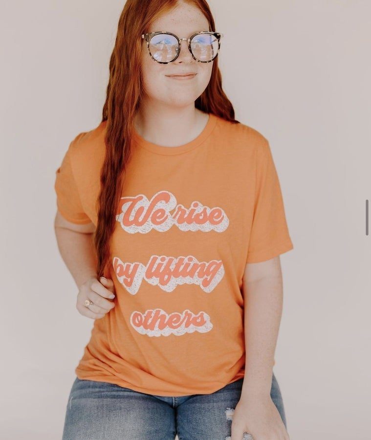 We Rise By Lifting Others Graphic Tee